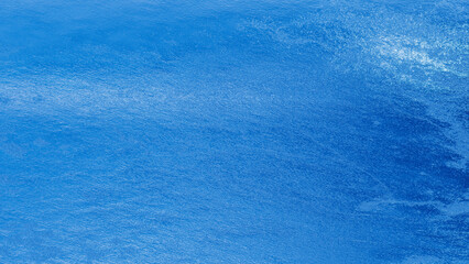 Blue plaster wall texture with subtle rough surface and gradient shades, abstract rustic background...