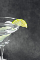 Refreshing cocktail with lime garnish served in elegant glass