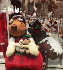 A soft brown teddy bear toy in a shop window. A holiday card for the New Year holiday.