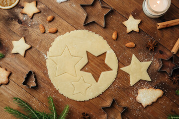 Christmas tree cookies with raw dough and wooden board for holiday food styling and festive background concept