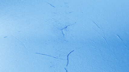 Blue plaster wall texture with subtle rough surface and gradient shades, abstract rustic background for design and decoration.