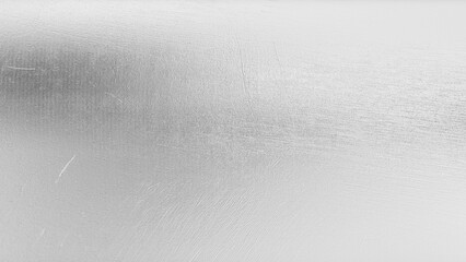 Close-up of shimmering silver metallic foil texture with polished, reflective highlights — a modern and luxurious backdrop perfect for elegant, futuristic, or high-end design concepts.