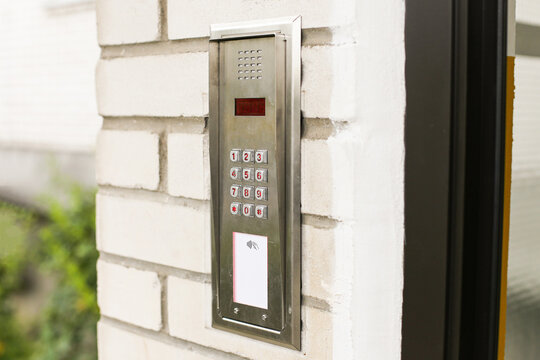 Modern intercom keypad with card reader on building wall. Secure access control system for apartments and offices. Electronic entry with buttons and RFID sensor. Safety technology for restricted entry