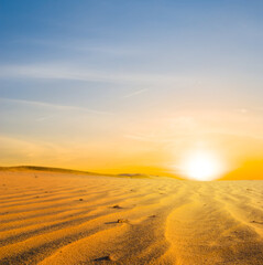 wide hot sandy desert at the dramatic sunset