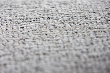 close-up shot of a tightly woven fabric with a mix of light gray and darker threads
