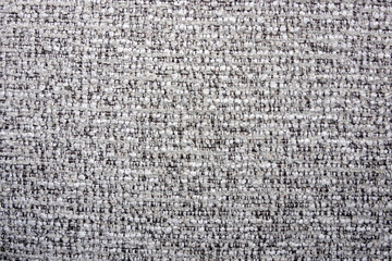 close-up shot of a tightly woven fabric with a mix of light gray and darker threads