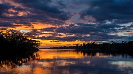 Obraz premium At sunset, a serene river, lakes reflecting vibrant colors, and lush rainforest landscapes on both sides capture the serene beauty of nature.