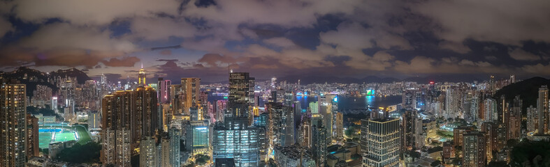 Obraz premium June 10 2025 Illuminated Cityscape with Modern Skyscrapers and Waterfront at Night