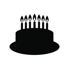 Black silhouette of birthday cake with lit candles