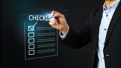 Businessman Completing Online Checklist on Laptop with Pen, Person Checking Items on a Checklist Using Pen and Laptop Digital Task Management Planning