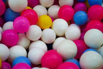 A vibrant collection of colorful plastic balls creates a playful and cheerful scene. The arrangement and textures add depth to capture a sense of fun and whimsicality for a dynamic backdrop.