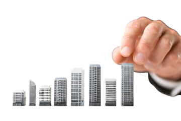 Hand placing model building showing growth in real estate