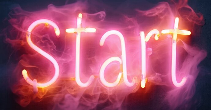 Bright neon sign displays Start text. Pink, orange hues create smoky background. Dramatic lighting emphasizes word.