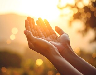 Human hands reaching out to the warm glow of the setting sun, symbolizing hope, blessing, and a connection to nature's serene beauty during a golden hour moment