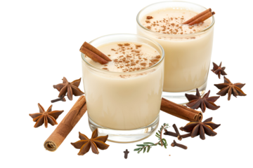 Two glasses of eggnog with cinnamon and star anise