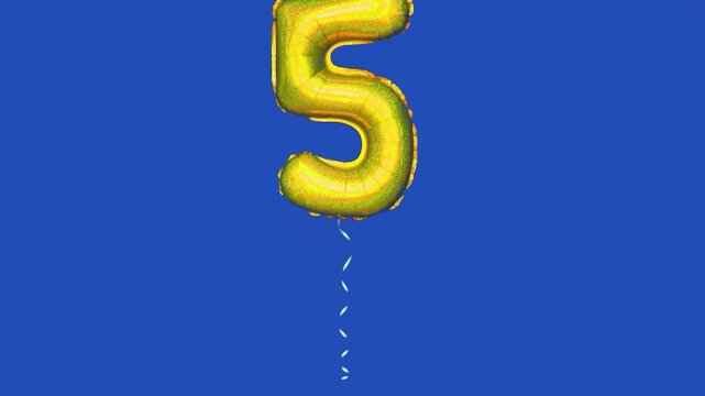 foil balloon with number 5 moving across blue screen