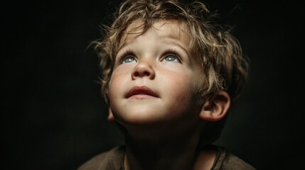 Close-up of a child looking upward in pure amazement with wide eyes and slightly open mouth, natural skin textures and subtle light reflections, cinematic soft key lighting on deep black background