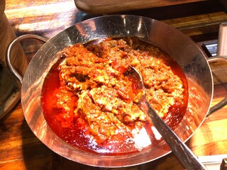 Beef Rendang in a serving dish with a spoon