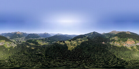 360 degrees aerial panorama of mountain slope with green meadows and pine tree divide with cloud obscuring half of the scenery. Picturesque colorful high altitude weather condition concept.