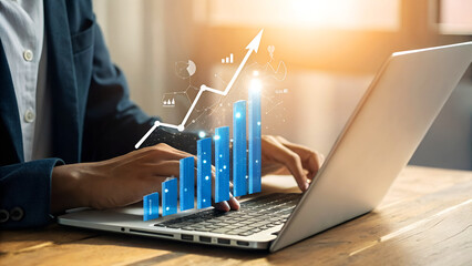 Successful businessperson analyzing financial data on laptop with growing bar graph, symbolizing growth, profit, and market success in modern office