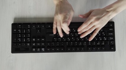 Top view of human hands typing on a black computer keyboard placed on a wooden desk. Concept of office work, digital communication, internet browsing, remote job tasks, online education, - Powered by Adobe