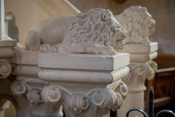 Langrune-Sur-Mer, France - 08 05 2025: Detail view of the stone staircase leading to the pulpit with its two lions on the pillars inside the Saint-Martin Church