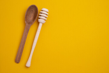 Wooden spoons for honey on background. Kitchen utensils