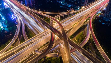 Aerial Nighttime Highway Interchange: Long Exposure Light Trails, Urban Infrastructure.