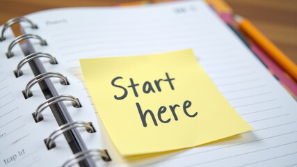 Notebook with first page reading start here written in casual handwriting