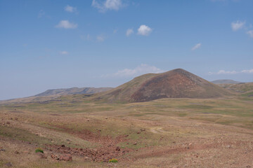 Expansive Mountain Landscape with Wildflowers and Cloudy Sky