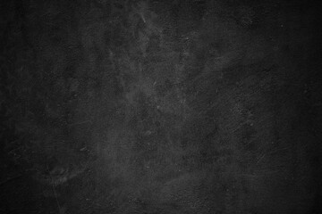 Dark textured background, black wall surface. Suitable for dramatic or industrial themed designs, backgrounds, or textures for projects.