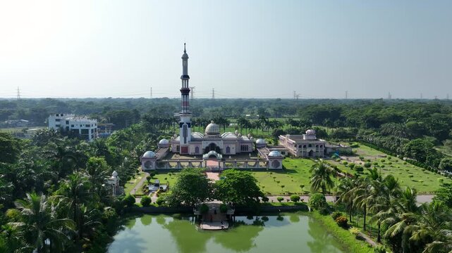 Barishal, Bangladesh - 22 August 2025: Aerial view of the Baitul Aman Jame Masjid Complex, a blend of modern and traditional Islamic architecture, stands in lush greenery.
