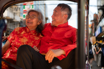 A happy senior couple in a Chinatown in Bangkok, Thailand,