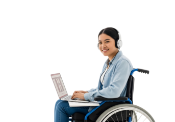 Young disabled woman in a wheelchair smiling and working on a laptop while wearing headphones