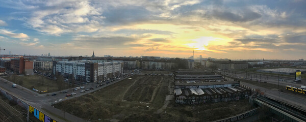 Urban panorama at sunset highlighting city buildings and open spaces