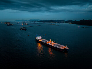 crude oil floating station in sea, bridge pipeline load unloading crude oil from oil ship transport, industry business transportation by container ship open sea, aerial drone point of view