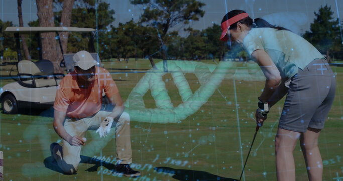 Golf partners wearing visors practicing putting on green, with putter, golf ball, DNA overlay - Powered by Adobe