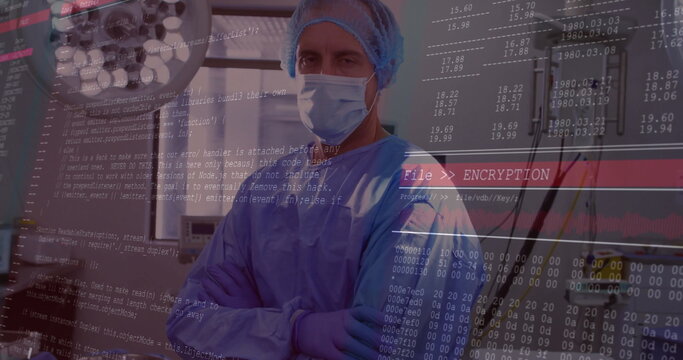 Standing cross-armed surgeon wearing gown in procedure room, with surgical light and code overlay