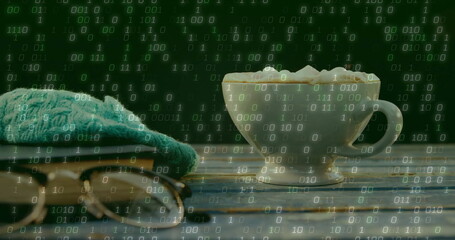 Showing white ceramic cup resting on blue table in dim room, eyeglasses, beanie, binary overlay