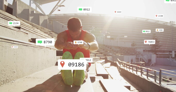 Stretching man in red tank reaching toward feet on stadium bleachers, with floating metrics icons