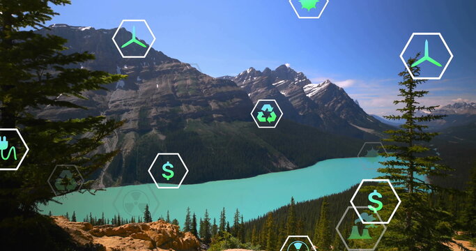 Fototapeta Showing turquoise glacial lake and rocky mountain peaks in valley, with hexagonal eco icons