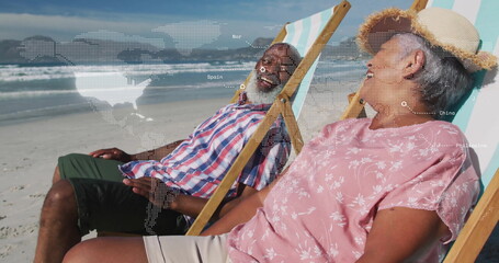 Couple relaxing on striped deck chairs on sandy beach, with straw sun hat, map overlay graphics