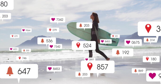 Striding female surfer in wetsuit across beach carrying surfboard with floating notification icons