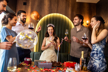 Friends Dancing Around Table at Birthday Celebration