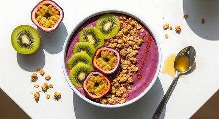 Vibrant acai bowl with fresh kiwi, passion fruit, and granola, drizzled with honey, a healthy breakfast treat.