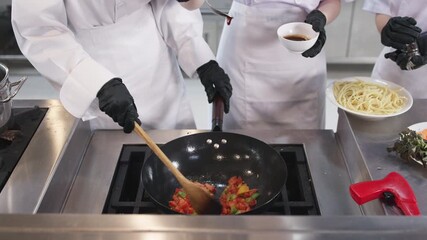 Chef instructor teaching students in kitchen class