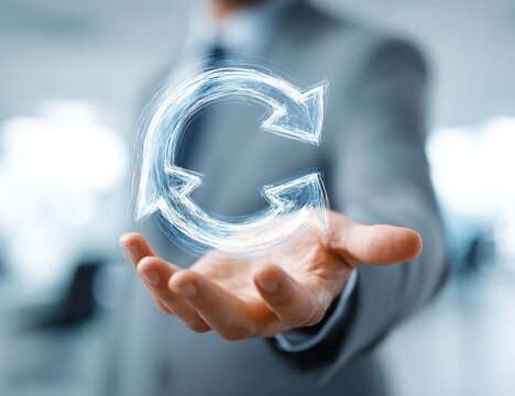 A man's hand holding a glowing digital circular arrow symbol