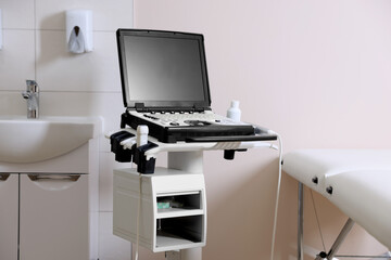 Modern ultrasound machine, sink and examination bed in clinic