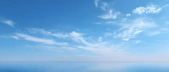 Obraz premium Serene ocean horizon with soft clouds under a bright blue sky peaceful nature scene