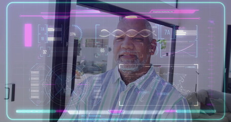 Standing man wearing striped shirt examining holographic interface in living area, with glass door